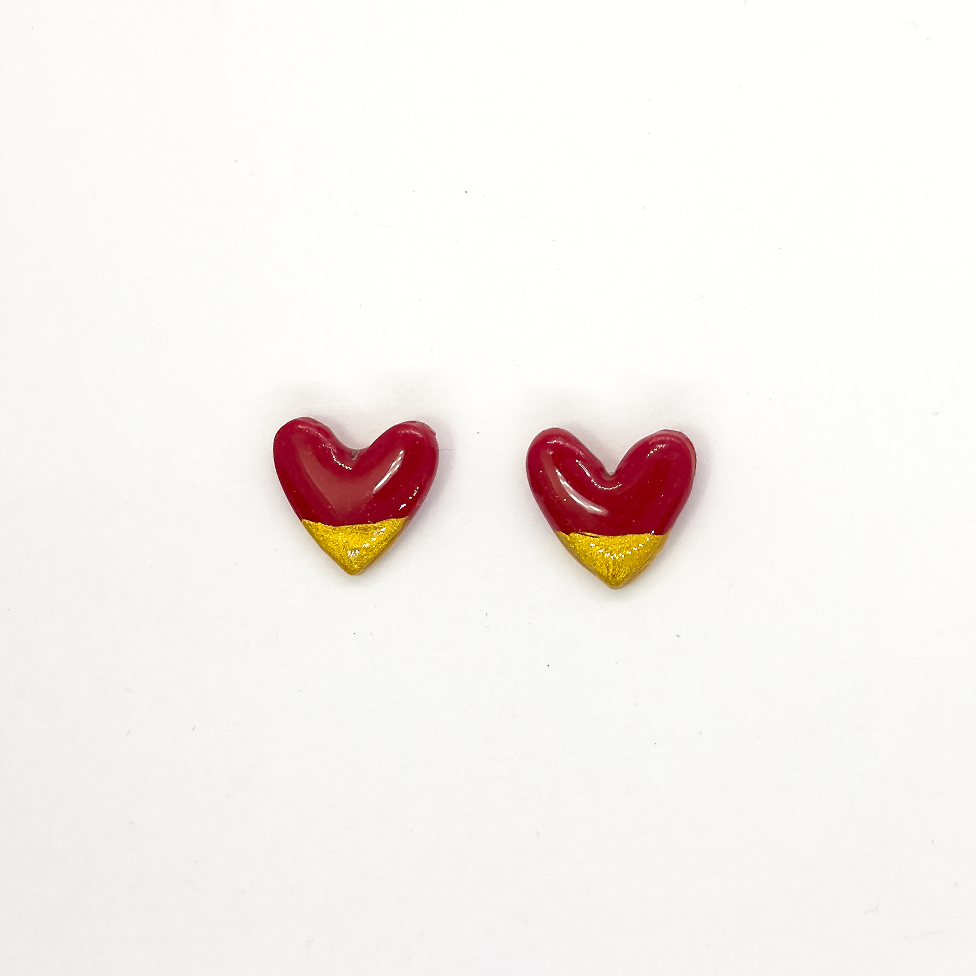 Small red, Ophelia heart earring with sparkly gold edging and high gloss finish, part of the seasonal collection.